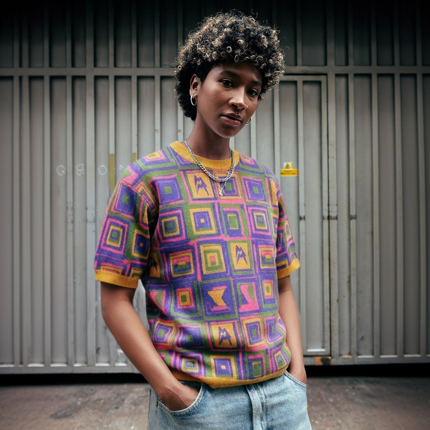 Vibrant retro-inspired op-art t-shirt with multicolor squares and saffron rib collar