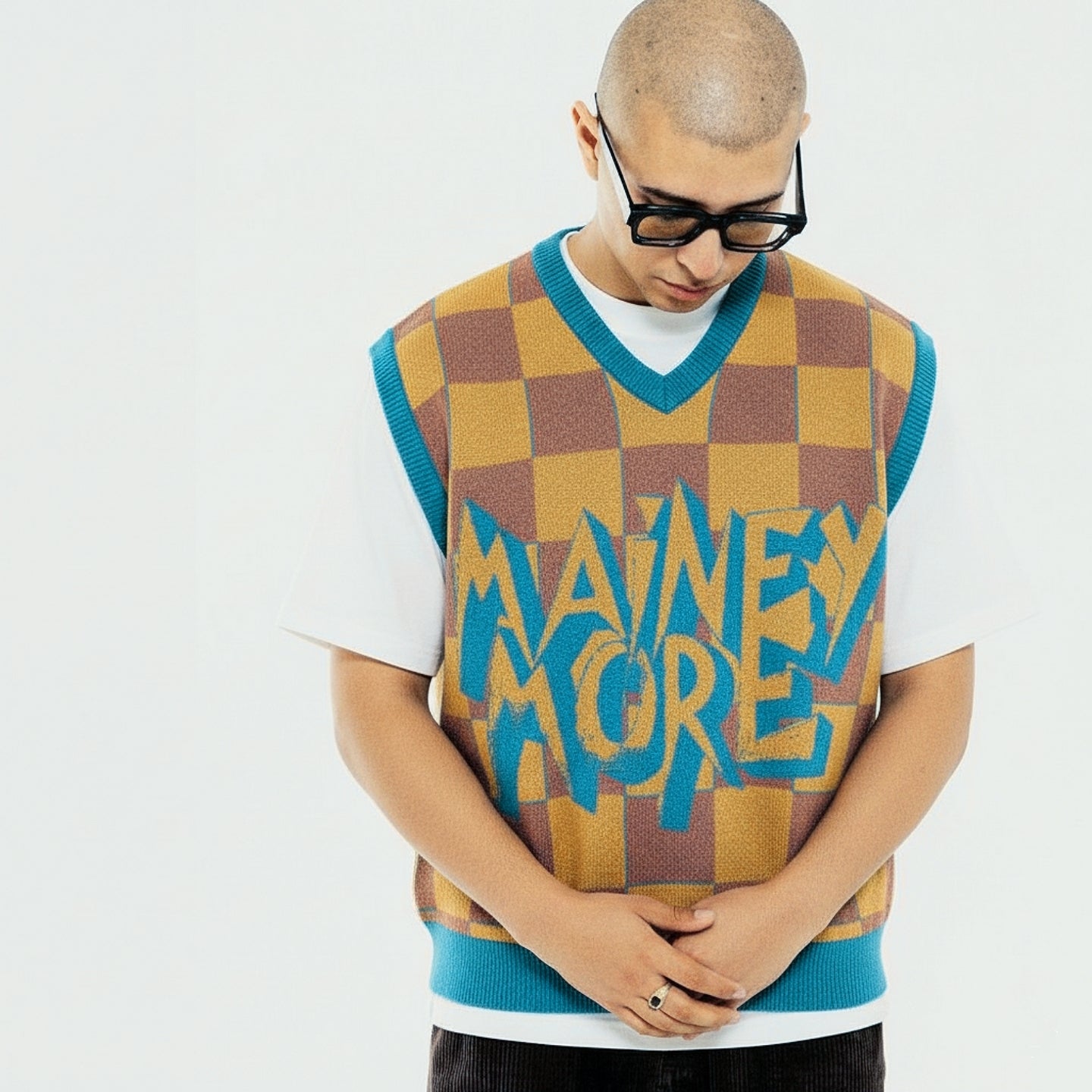 Checkerboard knit vest in warm tones with contrasting teal trims and large MAINEY MORE lettering