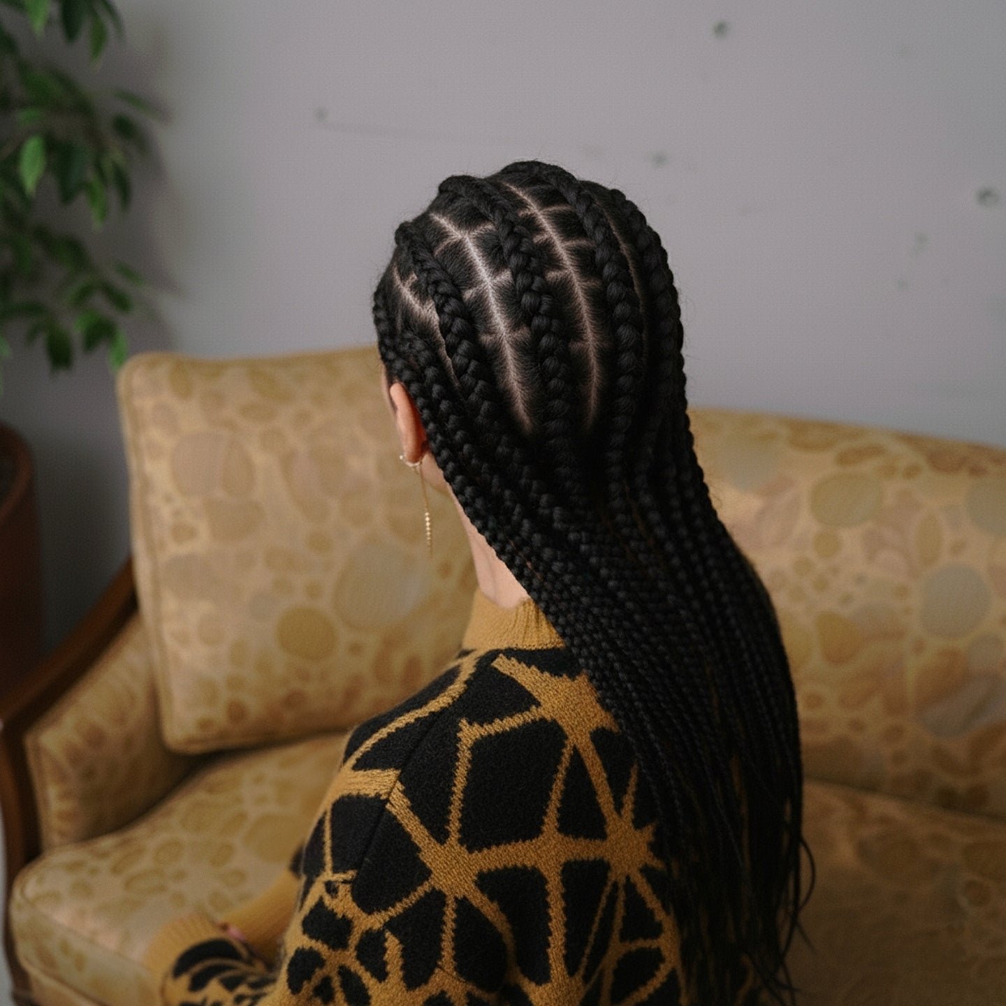 masterfully crafted crewneck sweater. Geometric gold-ochre lines radiate across a deep black base
