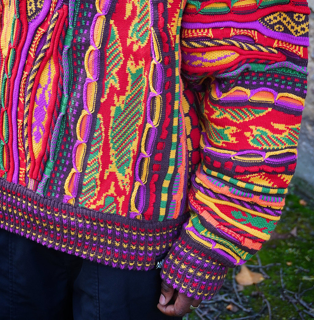 Oversized 3D knit sweater with vertical panels, each in a different knit structure